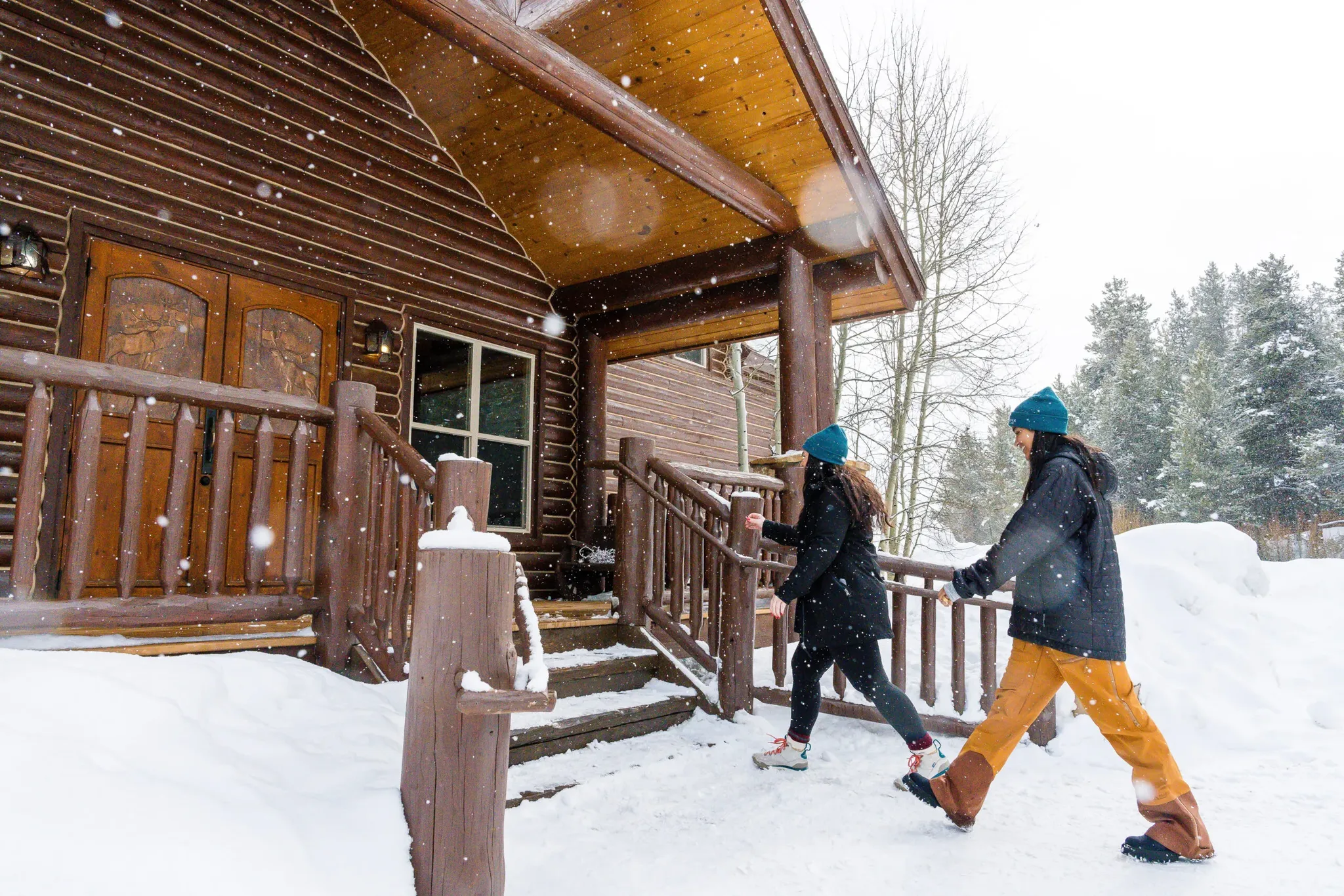 breckenridge snowmobile rental guests entering lodge on a snowy day.