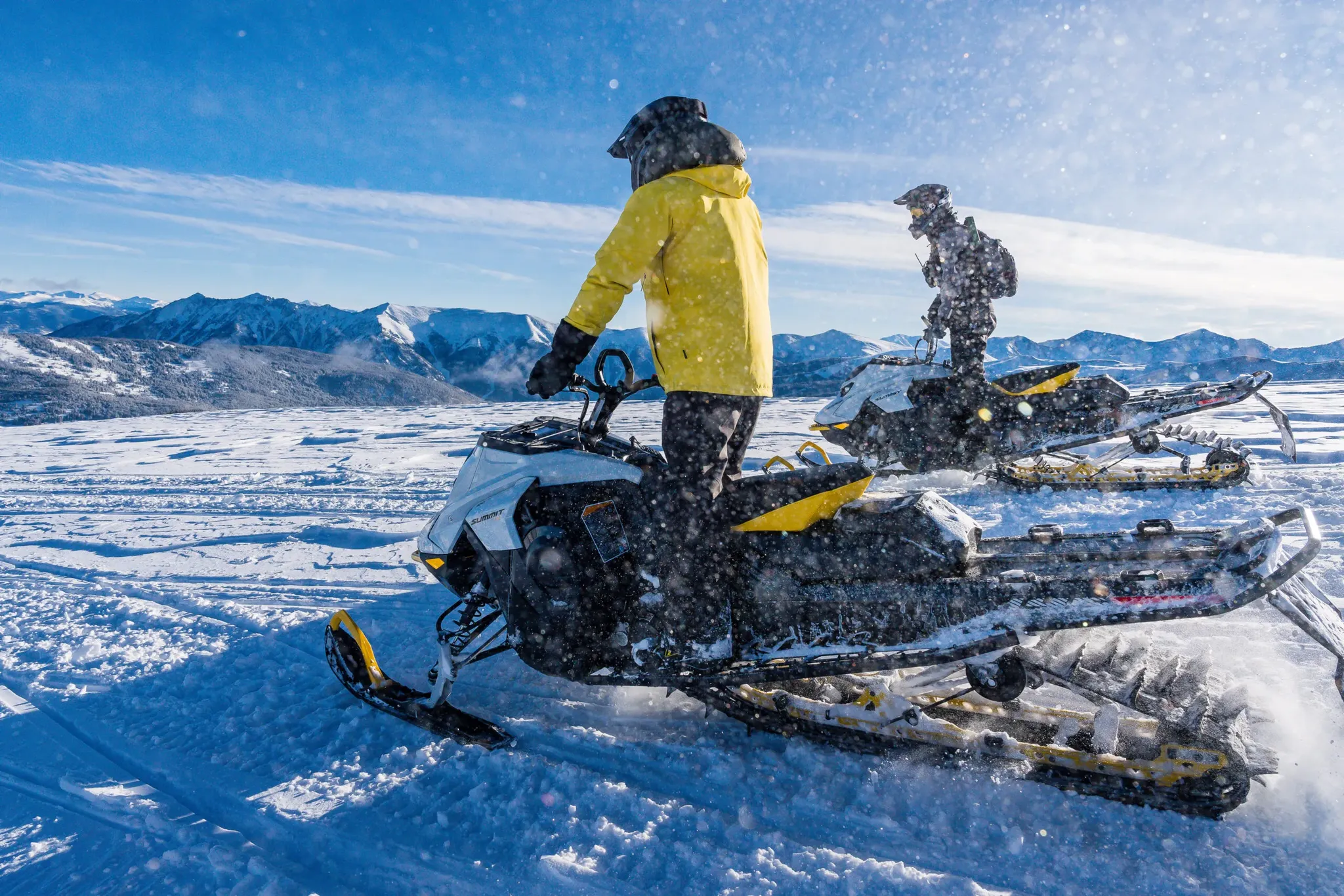 Two riders on a scenic Prospector guided snowmobile tour near Breckenridge, Colorado.
